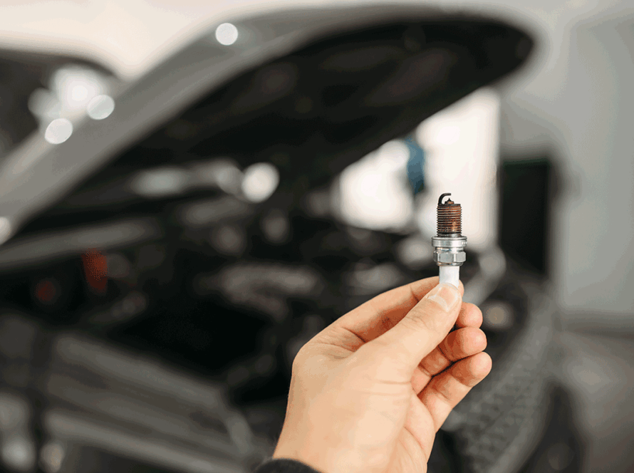 Mechanic shows spark plugs of the vehicle (1)