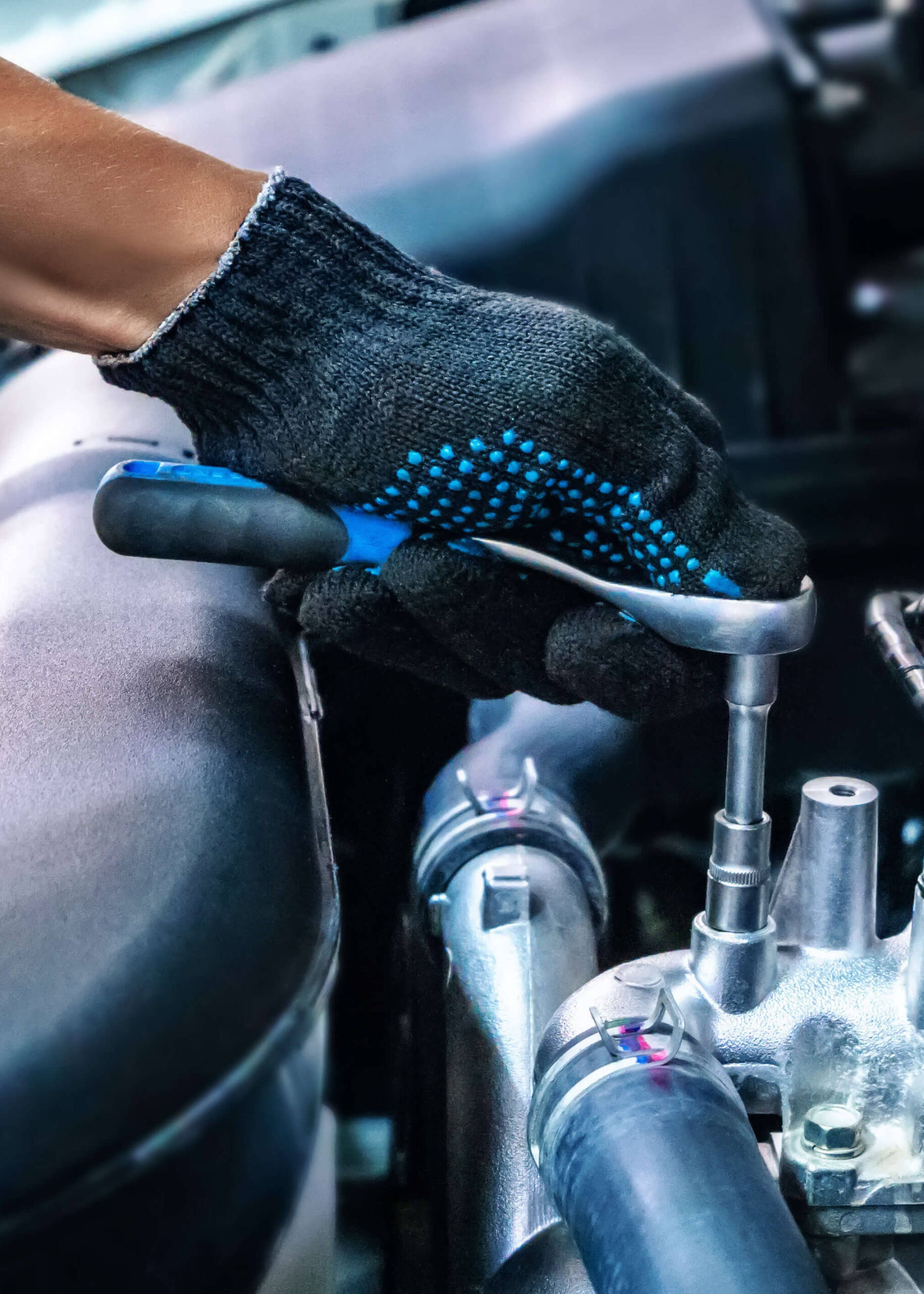 Auto mechanic working on car