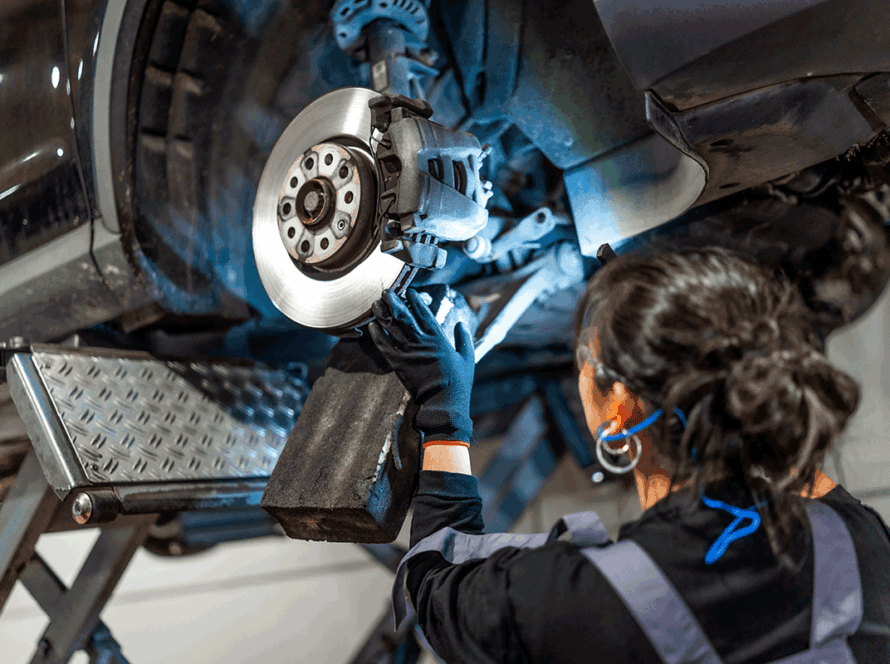 Mechanic fixing car brakes in auto repair
